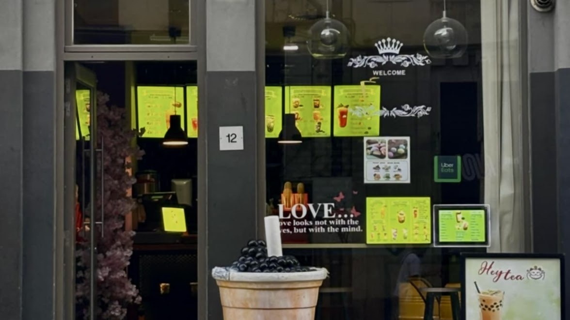 Shopfront window of Heytea Brussels with the drinks menu on display